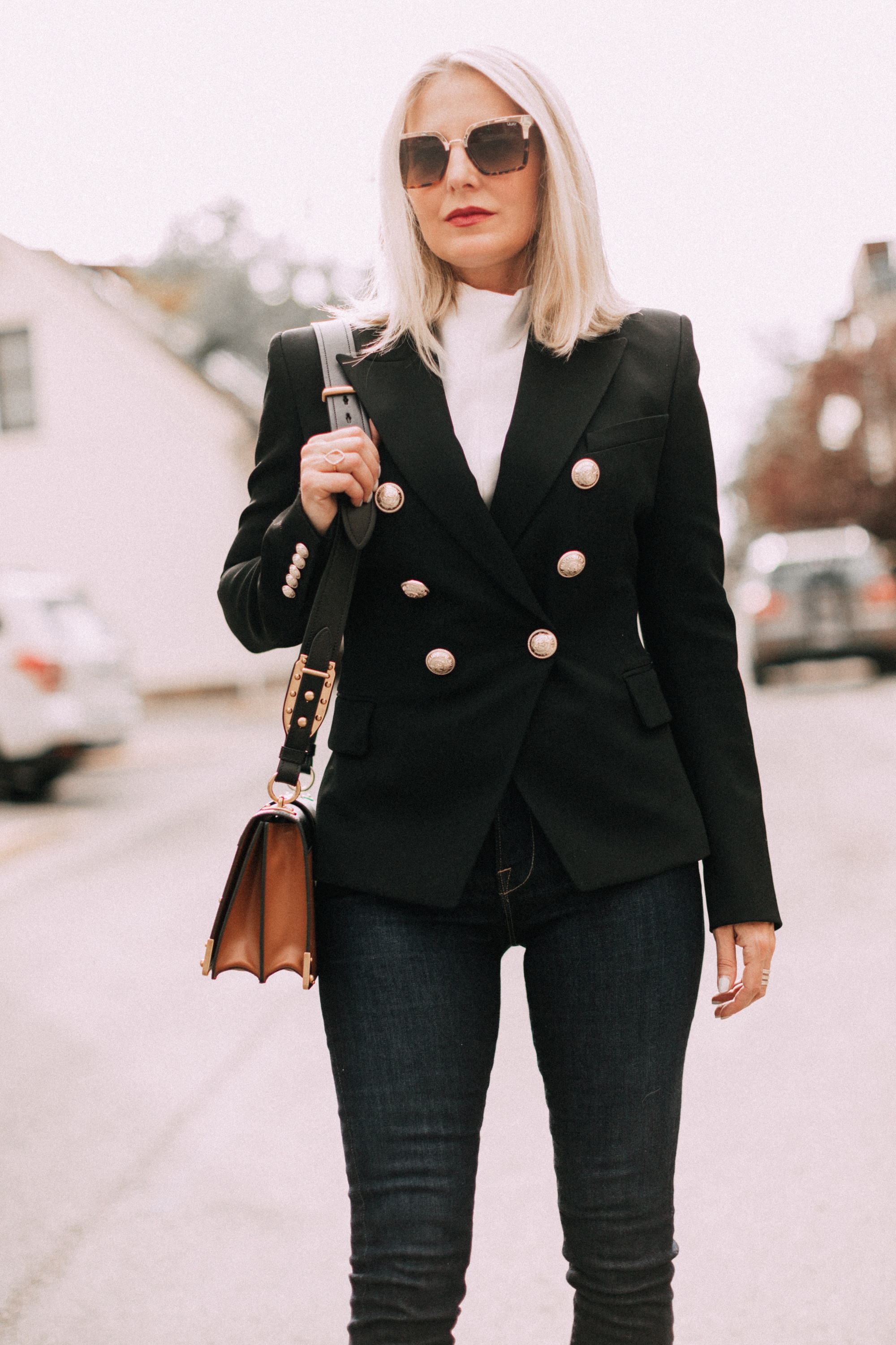 fashion blogger wearing black balmain double breasted wool blazer with dark wash jeans prada cahier crossbody handbag outfit