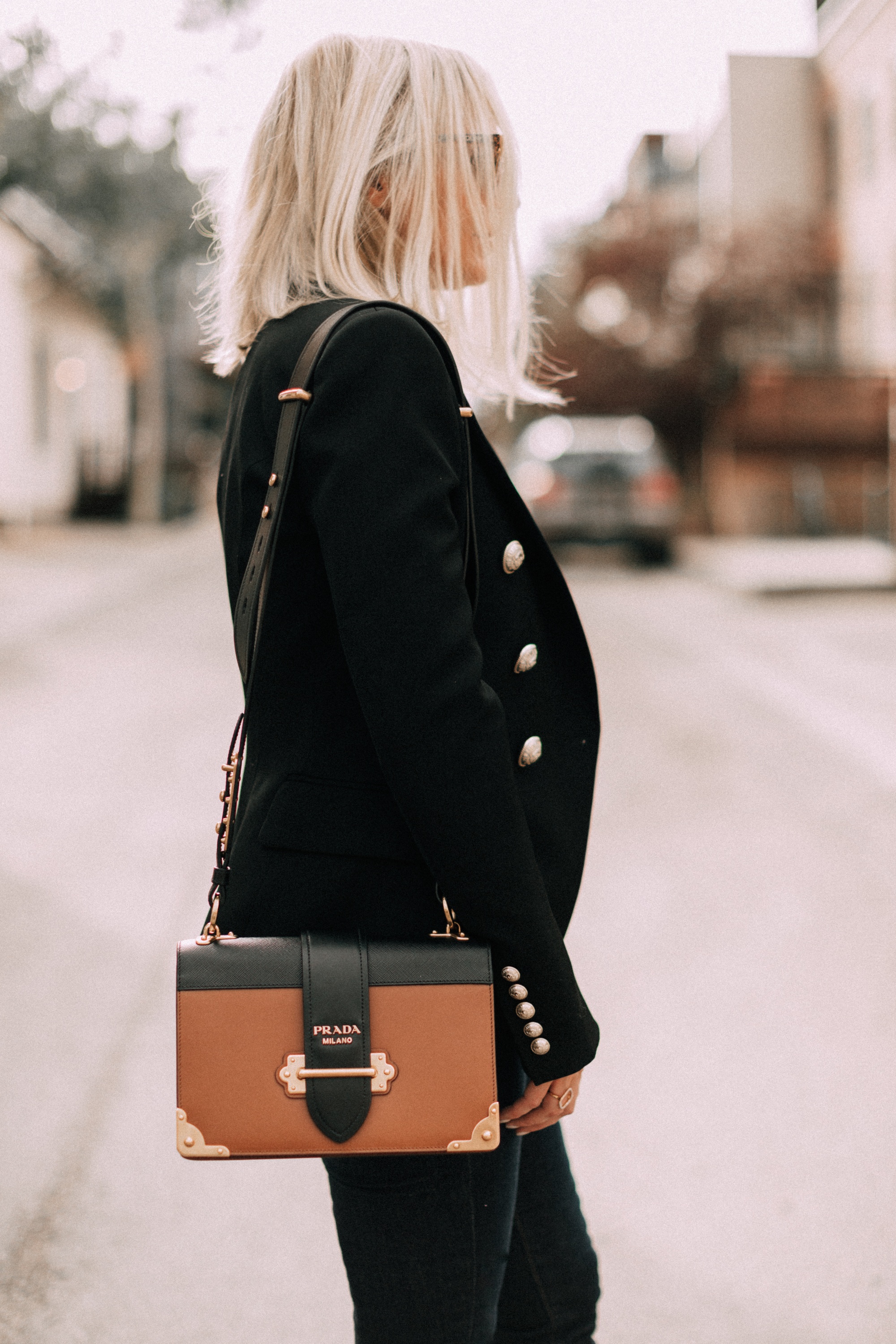 black balmain blazer outfit with dark wash jeans prada cahier leather crossbody handbag