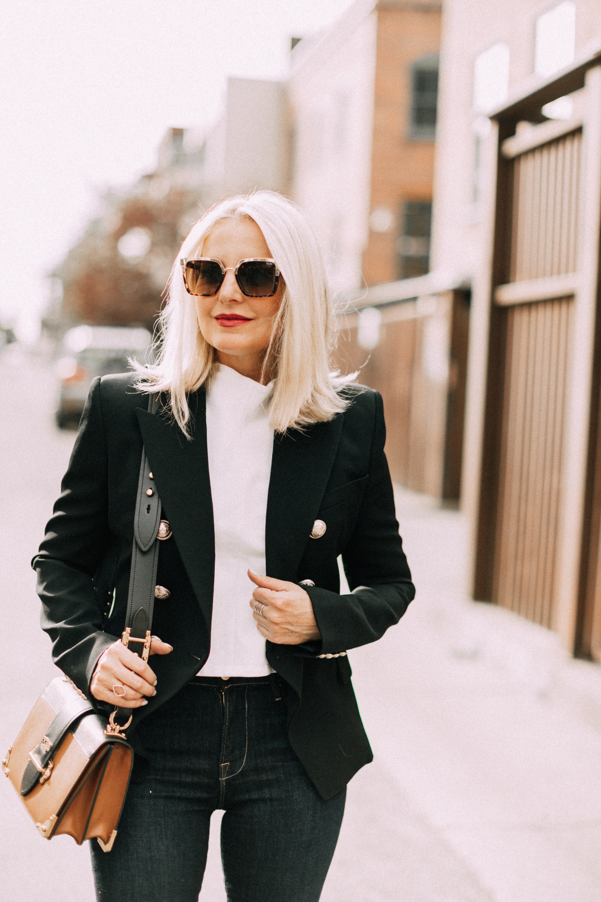 fashion blogger wearing black balmain double breasted wool blazer with dark wash jeans prada cahier crossbody handbag outfit